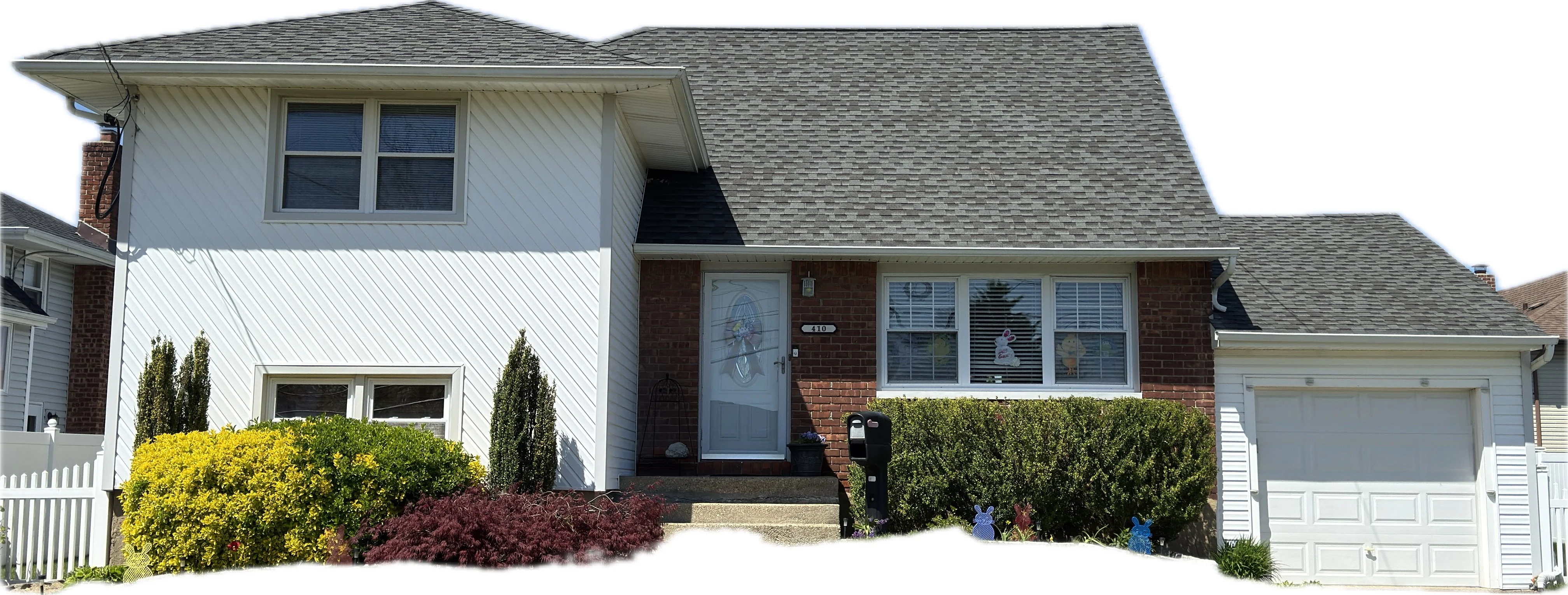 Two-story home with new gray roof, white siding, brick facade, and landscaped front yard