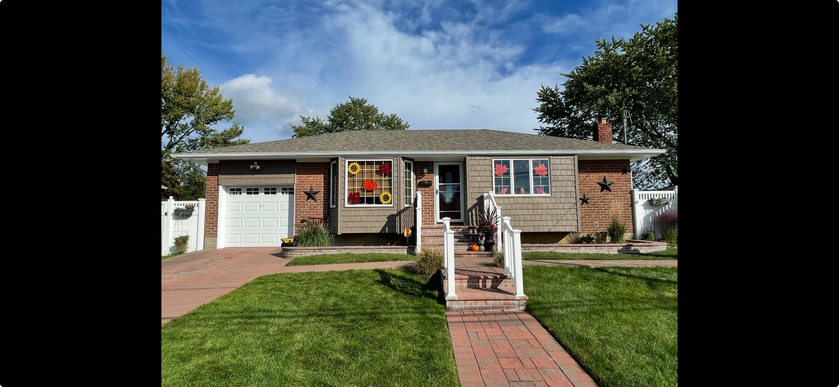 Brick ranch home with new roof, siding, windows, and brick paver driveway in Lindenhurst