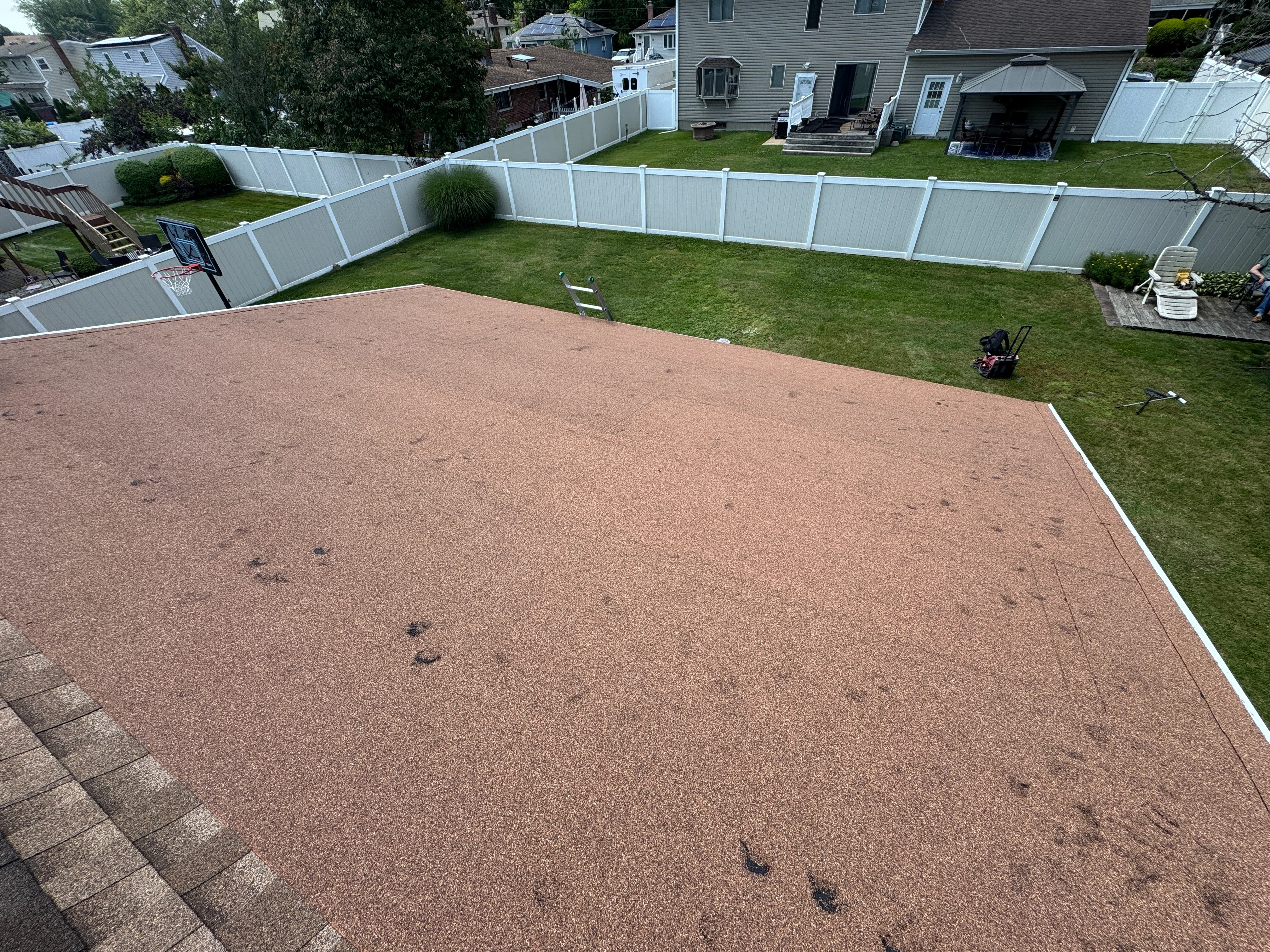 Newly installed brown architectural shingle roof with white trim edge on residential home